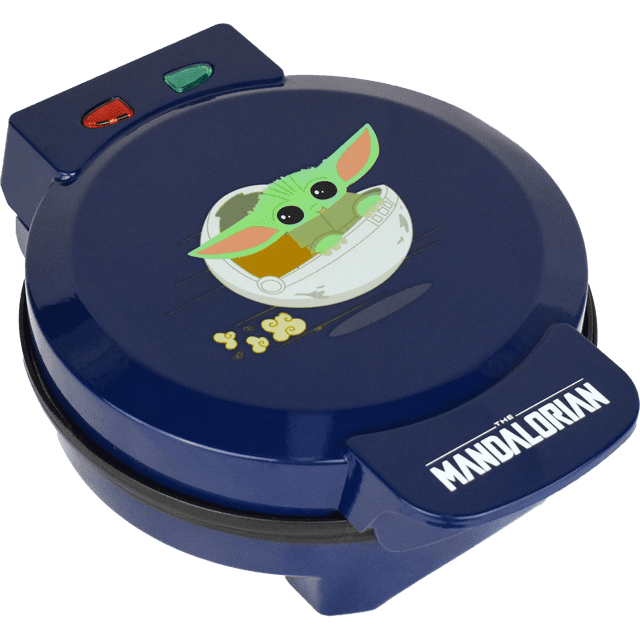 Star Wars Grogu (Baby Yoda) Waffle Maker by Uncanny Brands, featuring a compact blue design with Baby Yoda artwork on the lid. This non-stick waffle maker includes dual indicator lights, a regulated thermostat, and a weighted lid for even heating. Suitable for making waffles, eggs, brownies, cakes, quesadillas, or sandwiches. Designed for 120v systems in the US, Canada, and Mexico.