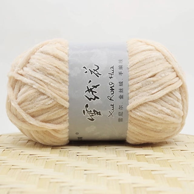 Zanvin Home Textiles Gold Velvet Chenille Medium Thick Wool Thread for DIY crochet projects like sweaters, scarves, and hats. The yarn is soft, durable, and measures 5mm in thickness, with a weight of 100g and a length of 180m. Displayed in a beige tone, the yarn is wrapped with a branded label and placed on a woven surface.