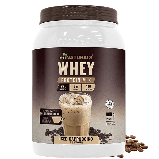 Whey Pure Isolate High Protein Drink Mix Powder in Iced Cappuccino Coffee flavour by miNATURALS, 900g container. Features 25g of protein per scoop, 3g of natural inulin fibre from chicory root, and 140 calories. Made with real Colombian coffee, providing as much caffeine as a cup of coffee. Gluten-free, 3rd party tested, and produced in a cGMP certified Canadian facility. The packaging highlights a creamy iced cappuccino drink with coffee beans scattered around.