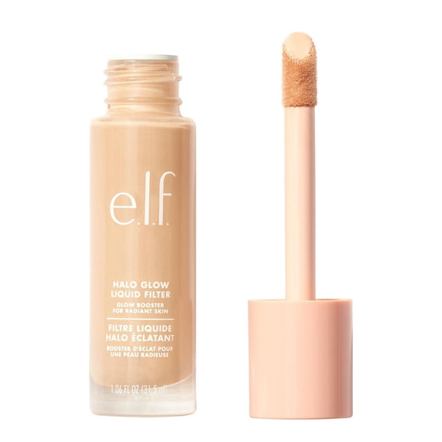 e.l.f. Cosmetics Halo Glow Liquid Filter in a clear glass bottle with beige liquid and white text, shown with a peach applicator wand featuring a sponge tip coated in the product, a makeup-skincare hybrid that boosts skin radiance and can be worn alone, under, or over makeup for a dewy finish.