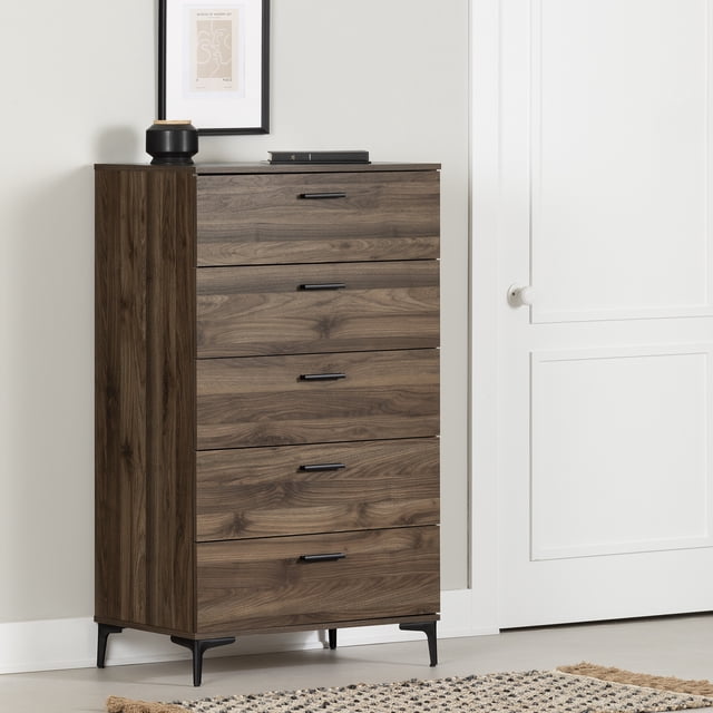 South Shore Musano 5-Drawer Chest with Metal Legs for Adult in natural walnut finish, featuring five smooth-glide drawers with thin black metal handles and slender metal legs, designed for efficient bedroom storage and minimalist decor, shown against a white wall with framed abstract art and decorative items on top, also suitable for organizing clothing categories neatly.