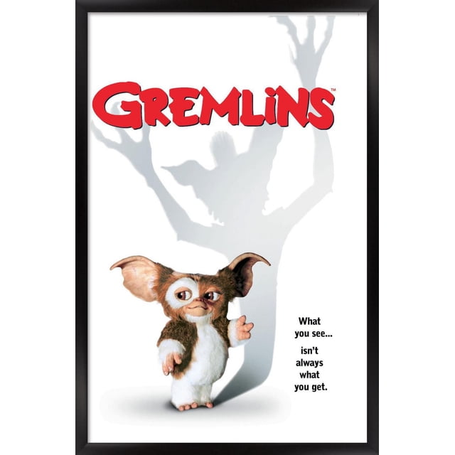 Gremlins - One Sheet Wall Poster, 22.375" x 34" depicting a small furry creature with large ears standing on a white background, casting a shadow of a larger, menacing figure with raised hands, with the text 'What you see... isn't always what you get.'