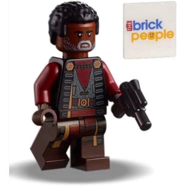 LEGO Star Wars: Greef Karga Minifigure with Blaster Pistol 75311. A multicolour LEGO minifigure featuring detailed molding and painting to resemble the Star Wars character Greef Karga. The figure is less than 2 inches tall and includes a blaster pistol accessory. Suitable for ages 6+, compatible with standard LEGO sets.