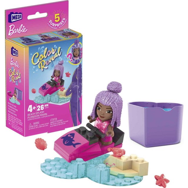 MEGA Barbie Color Reveal Beach Splash Construction Set with a pink and black jet ski featuring a fish graphic, a purple-haired micro-doll in a pink outfit, translucent blue building blocks simulating water, beige blocks forming a beach base, a purple heart-shaped container, and two small sea creature accessories including a pink starfish and a pink shell.