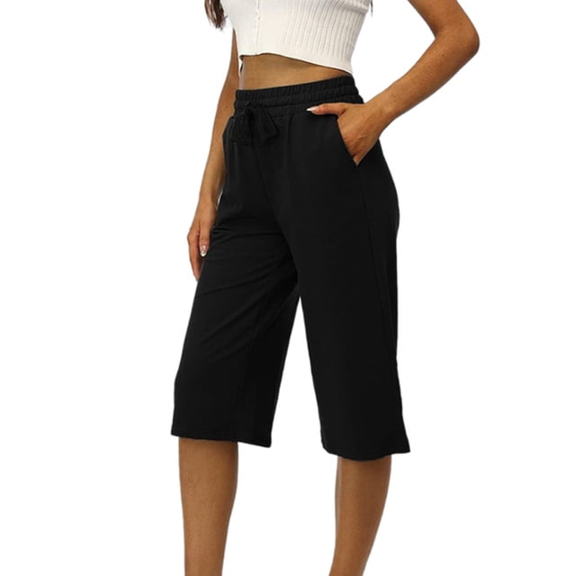 Summer Rollbacks Georges Hiking Pants Joggers Woman Fashion Drawstring Pockets Elastic Waist Solid Capris Pants in black polyester fabric. Features include a casual design, elastic waistband, drawstring closure, and side pockets. Ideal for women's bottoms, these capris pants are suitable for casual wear, lounging, or outdoor activities. Styled as mid-length capris with a relaxed fit.
