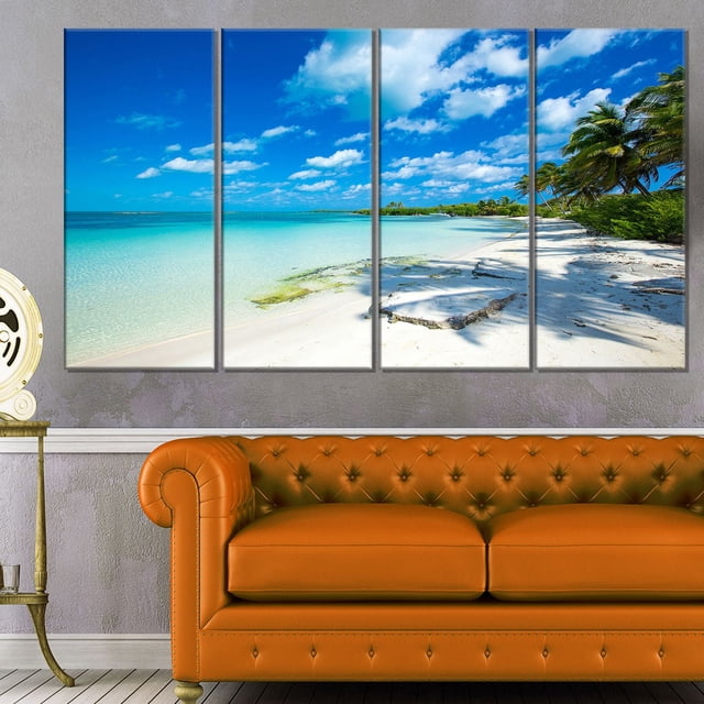 Design Art Plage Tropicale avec Ombres de Palmiers Grande Impression sur Toile de Bord de Mer, une Toile en Coton Enveloppée à Cinq Panneaux Mesurant 48 par 28 Pouces, Représentant une Plage Tropicale avec des Eaux turquoise Claires, du Sable Blanc, des Ombres de Palmier et un Ciel Bleu Partiellement Nuageux, Prête à Accrocher dans un Salon Moderne au-Dessus d'Un sofa en Cuir orange, Idéale pour Ajouter une Déco Côtière Vibrante.