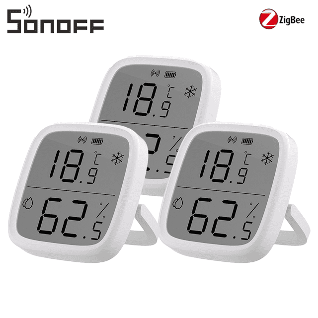 SONOFF Zigbee Smart Indoor Temperature Humidity Sensor, SNZB-02D Zigbee wireless Hygrometer Thermometer 3-pack. Each sensor features a 2.5-inch LCD display with bold, easy-to-read numbers showing temperature and humidity levels. The display includes intuitive icons for hot, cold, dry, and wet air conditions, as well as battery status. Designed for Zigbee 3.0 compatibility, these sensors provide real-time monitoring and alerts via app integration. Suitable for various spaces like living rooms, kitchens, or greenhouses, with multiple mounting options including tabletop, magnetic back, or adhesive. White casing with a compact, modern design.