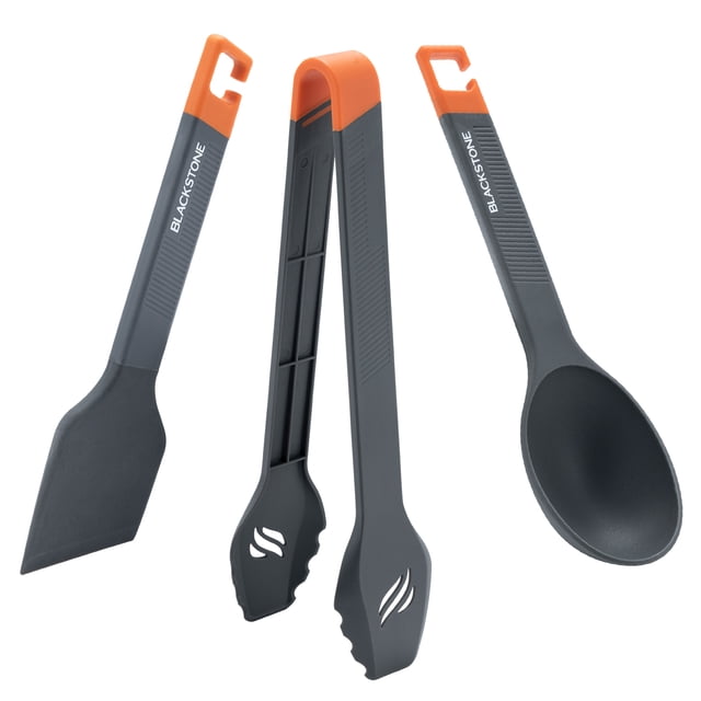 Blackstone Camping Toolkit, 3 Piece set with grey large serving spoon, silicone scraper, and utility tongs featuring orange handles, ideal for camp kitchen use and compatible with Blackstone griddles for easy camp cooking.