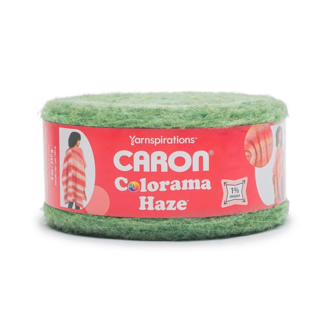 Caron® Colorama Haze™ Yarn, bulky #4 medium weight acrylic blend in green, shown as a round skein with a red label featuring the brand and product name, suitable for knitting and crochet projects.