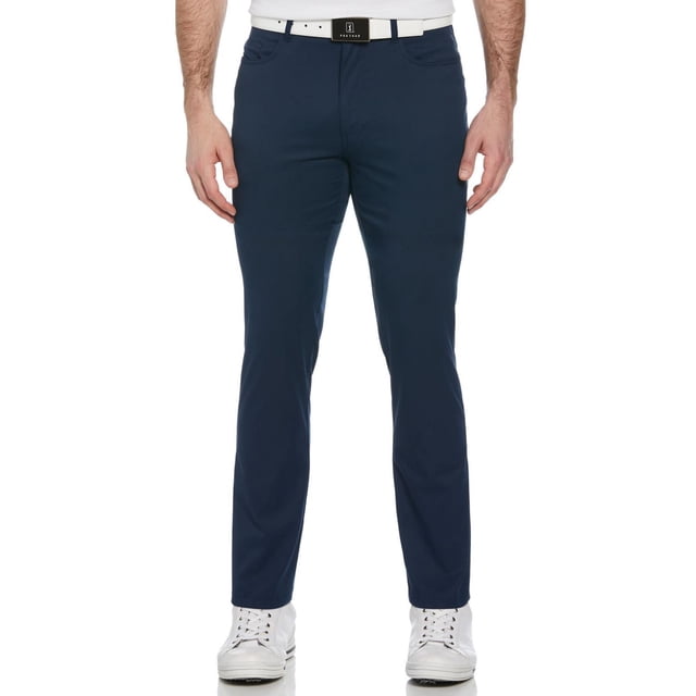 PGA TOUR Course Essentials Men's Stretch 5 Pocket Dress Pant with Comfort Waist in navy blue, front view showing slim fit golf pants with MOTIONFLUX™ 360 performance stretch fabric and comfort stretch waistband, styled with a white belt and white golf shoes, also suitable for casual outdoor wear.