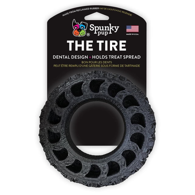 The Tire Dog Toy - USA Made by Spunky Pup, a black circular chew toy made from reclaimed rubber with a grooved dental design that holds treat spreads to support dogs' oral health, shown on black packaging with brand logo and American flag, ideal for interactive chewing and treat play.