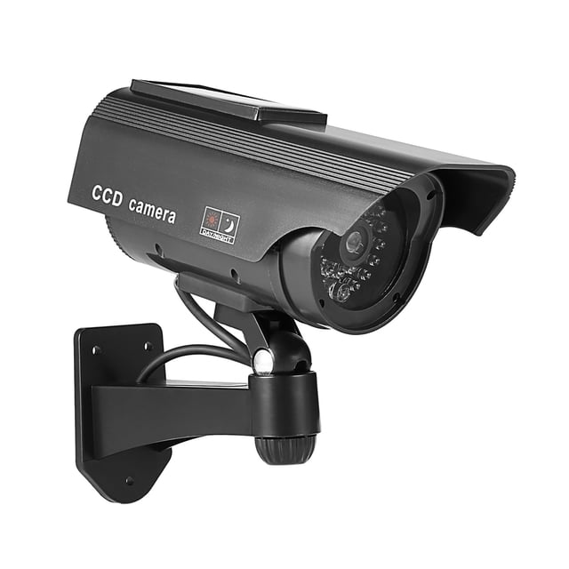 Outdoor Lights Solar Powered Solar Outdoor Lights designed as a black ABS dummy security camera with a realistic simulation lens and flashing red LED light. The solar-powered unit is mounted on a wall bracket, ideal for indoor and outdoor use in homes, offices, shops, and garages. It is IP65 waterproof, easy to install, and includes mounting accessories.