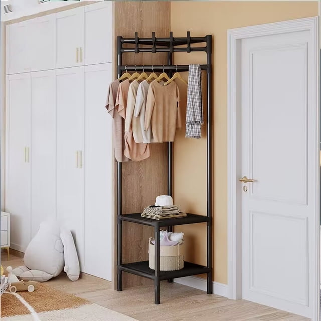 Jubipavy Coat Rack Freestanding Closet Organizer Hall Tree with 2 Storage Shelves, designed for entryways or bedrooms. The black plastic and stainless steel structure includes a top rod with hangers for clothes, two hat hooks, and two lower shelves for shoes or bags. Positioned in a corner, it complements a beige wall and white door.