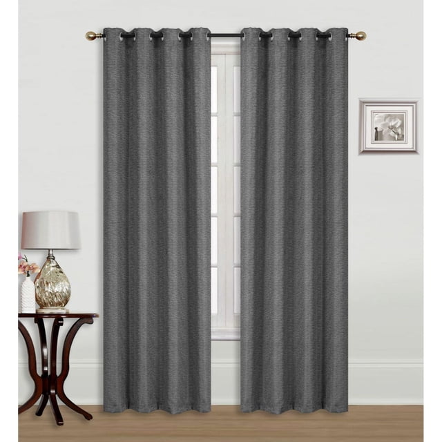 Jacquard Blackout Panel W 8 Grom -Linea -Light Gray set of two light gray jacquard blackout curtains with diamond braid design and eight metal grommets on a black rod, blocking sunlight in a room with white walls, wooden floor, side table with lamp, and framed flower art