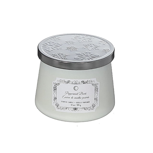 Christmas 10.5Oz Taper Candle Peppermint Bark in a white wax tapered jar with a silver lid embossed with snowflake patterns and a decorative label, suitable for creating a cozy festive ambiance in indoor Christmas decorations.