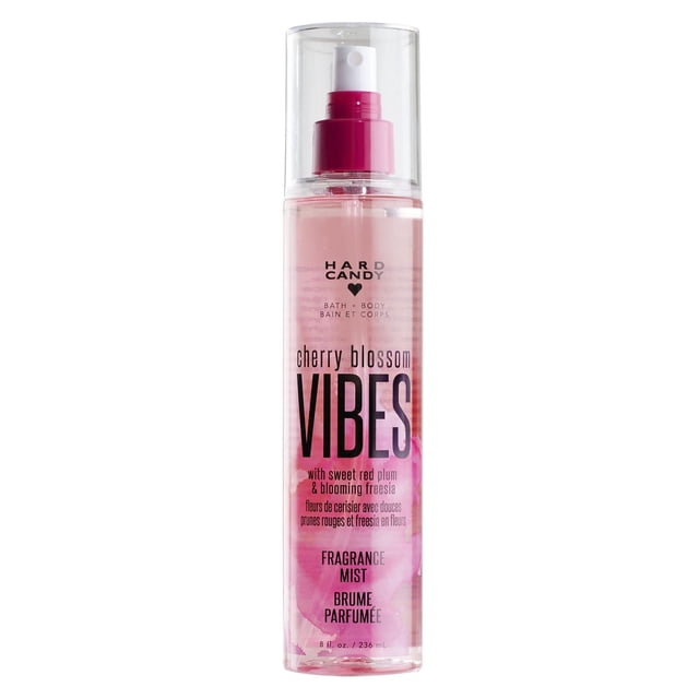 Hard Candy Cherry Blossom Vibes Fragrance Mist in a clear 236 mL spray bottle with pink liquid and a pink spray nozzle, featuring floral notes of sweet red plum and blooming freesia, suitable for refreshing bath and body use.