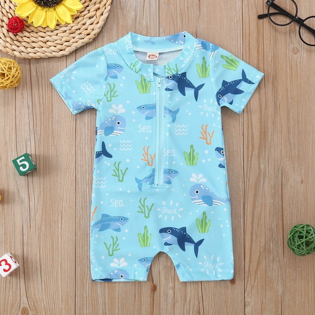 Baby Swimsuits Cute Cartoon Printed Kids Bathing Suits Boy Rash Guard Swim Suits Boys 3-6M Boys Clothes. A short-sleeve baby boy swimwear in light blue with colorful cartoon sea animal prints, including sharks, whales, and coral. Designed with a front zipper for convenience and made from lightweight, quick-dry fabric for comfort during summer activities like swimming, beach outings, and pool parties.