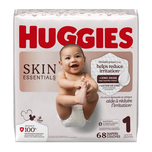 Huggies Skin Essentials Baby Diapers, Size 1 (8-14 lbs), 68 count pack showing a baby wearing a diaper with Disney patterns. The packaging highlights a clinically proven zinc oxide enriched liner that helps reduce irritation, is hypoallergenic, fragrance-free, and provides up to 100% leak and blowout protection.