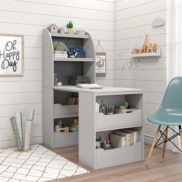 Ameriwood Home Tyler Kids Craft Desk in dove gray with a large work surface and six shelves for storing books, craft supplies, and decor, featuring a reversible back panel in light and dark gray to match any child's room style.