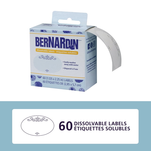 Bernardin Dissolvable Labels, 60 Count box with a partially dispensed roll of white oval labels featuring decorative borders, designed to adhere securely on jars and dissolve easily with water for easy cleanup, easy to write on and dishwasher safe.