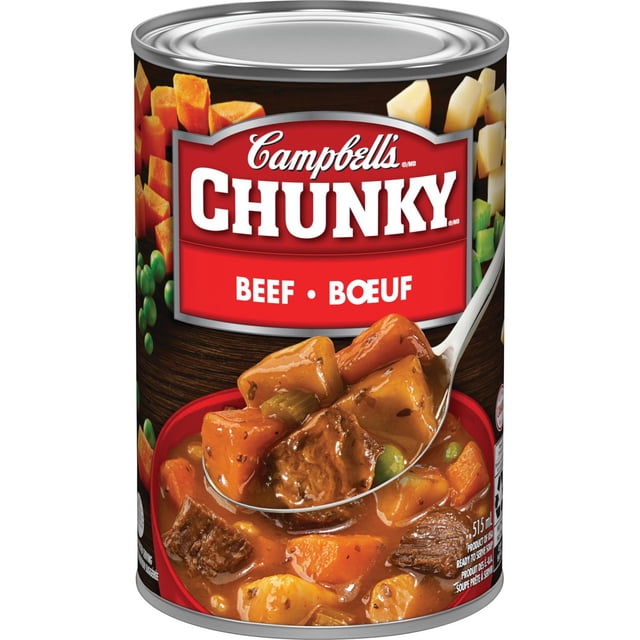 Campbell's® Chunky® Beef Ready to Serve Soup, Shelf Stable canned soup with a red label showing the brand and product name in English and French. The label features a close-up of chunky beef soup containing large pieces of seasoned beef, carrots, potatoes, and peas in a herb-infused brown gravy, highlighting its hearty vegetables and quality meats, ideal for pantry food and canned beef soup needs.
