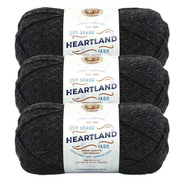 Lion Brand Yarn Heartland Yarn 3Pack featuring three skeins of medium worsted weight yarn in dark heathered charcoal, made of 100% acrylic fiber that is machine washable and dryable, each wrapped with a white label displaying the brand and product name, suitable for knitting and crochet projects.