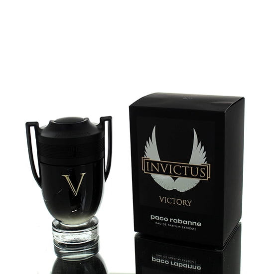 Invictus Victory by Paco Rabanne Eau De Parfum Extreme Spray 3.4 oz for Men. The image displays a black trophy-shaped bottle with a gold 'V' emblem, symbolizing strength and victory, alongside its black box featuring the Invictus Victory logo with white wings. Though categorized under women's fragrances, this product is designed for men, offering a bold and intense scent.