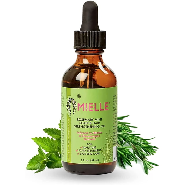 Mielle Organics Rosemary Mint Scalp & Hair Strengthening Oil, a 59ml amber glass bottle with a black dropper cap, featuring a green label with pink branding and product details. The label highlights biotin infusion and growth encouragement. Fresh rosemary and mint leaves are displayed beside the bottle, suitable as a scalp oil for daily use and split end care.