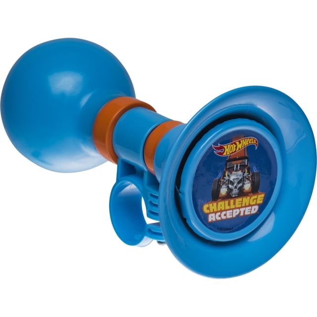 Bell Sports Hot Wheels Classic Bike Horn Blue with a bulb-style blue plastic body and orange accents. The horn face shows a Hot Wheels 'Challenge Accepted' graphic featuring a skull car. It fits most bikes, trikes, and scooters, suitable for kids aged 3 and up.