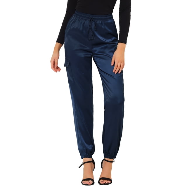 Unique Bargains Women's Drawstring Elastic High Rise Silky Satin Cargo Solid Pants in royal blue, size M. These high-waisted pants feature a relaxed fit, elastic waistband with drawstring, and cargo pockets for a stylish yet functional design. Made from soft satin fabric, they offer a sleek, lightweight feel. The pants are paired with black heels and a black top, showcasing their versatility for casual or dressy occasions.