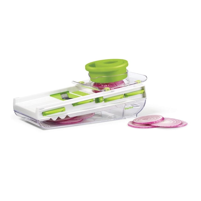 Starfrit Easy Mandoline kitchen slicer with white and green design, featuring a transparent container base holding sliced red onions, a green ergonomic hand guard securing an onion on the blade, and three onion slices beside it on a white background, ideal for slicing, dicing, and shredding vegetables.