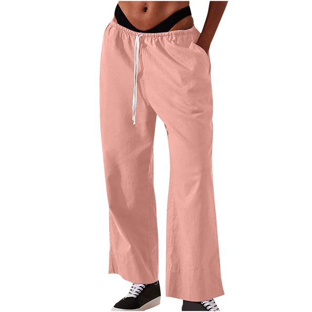 Timegard Womens Cotton Linen Pants with an elastic waist, wide-leg cut, and solid color design. These lounge pants feature side pockets and are ideal for casual wear or lounging. Displayed in a light pink tone, styled with black sneakers for a relaxed look.