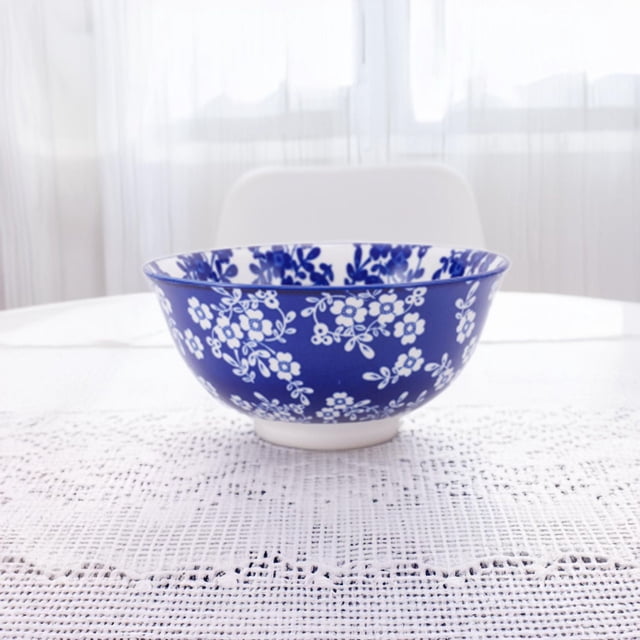 Mainstays 6.25" pad printed bowl in blue stoneware with white floral patterns, perfect for salads or everyday dining, shown on a white textured tablecloth in a bright setting, also suitable for serving snacks.