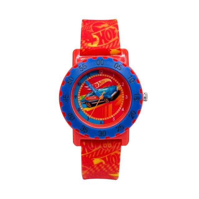 Hot Wheels Montre Analogique pour Garçons avec Boîtier en Plastique Rouge et Lunette Bleue Marquée de minutes. le Cadran Montre un Graphique Hot Wheels Mettant en Vedette une Voiture Bleue et des Aiguilles des Heures et des minutes Étiquetées. Il a un Bracelet en silicone Rouge avec des logos Hot Wheels Jaunes et une Boucle Métallique, Convient aux Jeunes Garçons Qui Apprennent à Indiquer l'Heure.