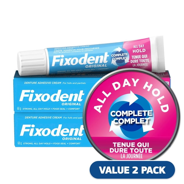 Fixodent Crème Adhésive Originale Complète pour Dentiers, Lot de 2 avec Deux tubes de 68 g, Offrant une Tenue Solide Toute la Journée, un Joint Alimentaire et un Confort pour Dentiers Complets et Partiels, Montré avec un Emballage Bleu et Rose Mettant en Valeur et un Ajustement Complet.