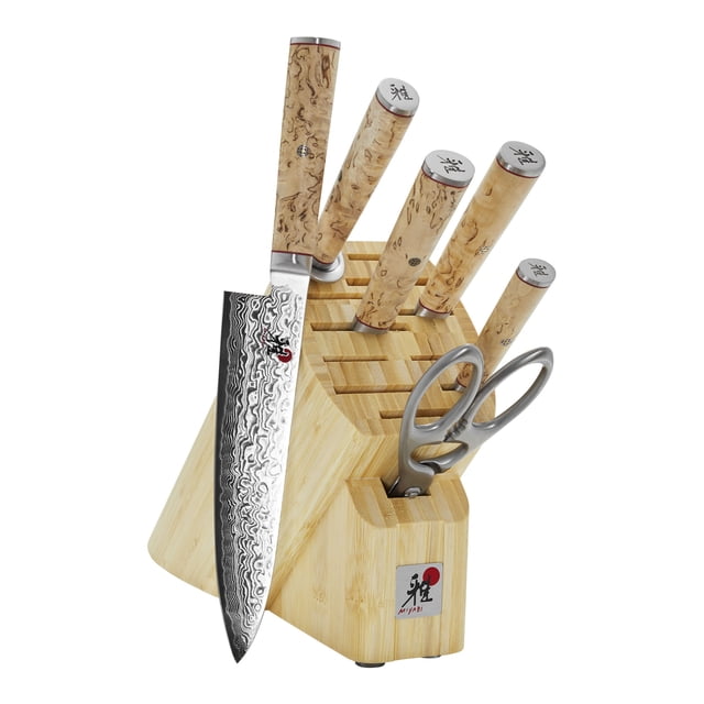 MIYABI 5000 MCD 7 Piece Knife Block Set in brown, featuring a bamboo block with 12 slots and knives with ergonomic Karelian Birch handles. Includes 3.5-inch paring knife, 7-inch Santoku knife, 8-inch chef knife, 8-inch bread knife, 9-inch sharpening steel, and shears. The blades showcase a 101-layer flower Damascus design and are crafted from SG2 micro-carbide powder steel, ice-hardened to Rockwell 63. Handcrafted in Seki, Japan, highlighting Japanese craftsmanship.
