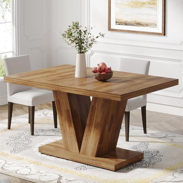 Tribesigns 47-inch dining table for 4, featuring a walnut wood finish and a contemporary V-shaped base. The table measures 47.2 inches wide, 31.5 inches deep, and 29.9 inches high, accommodating up to 4-6 people. It is displayed in a bright dining room setting with white chairs and a decorative centerpiece on top.