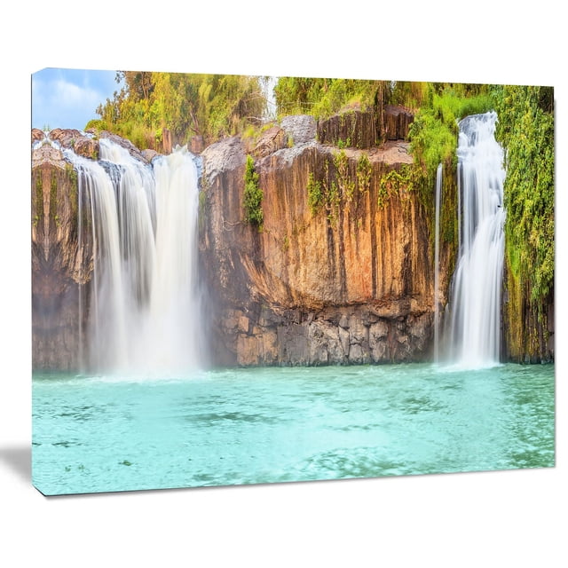 Design Art Dry Sap Waterfall Canvas Print featuring a gallery wrapped cotton canvas with a high-resolution image of two waterfalls cascading over rocky cliffs into turquoise water, surrounded by green foliage, ready to hang with included hardware and a solid 1-inch wood subframe, designed and made in Canada.