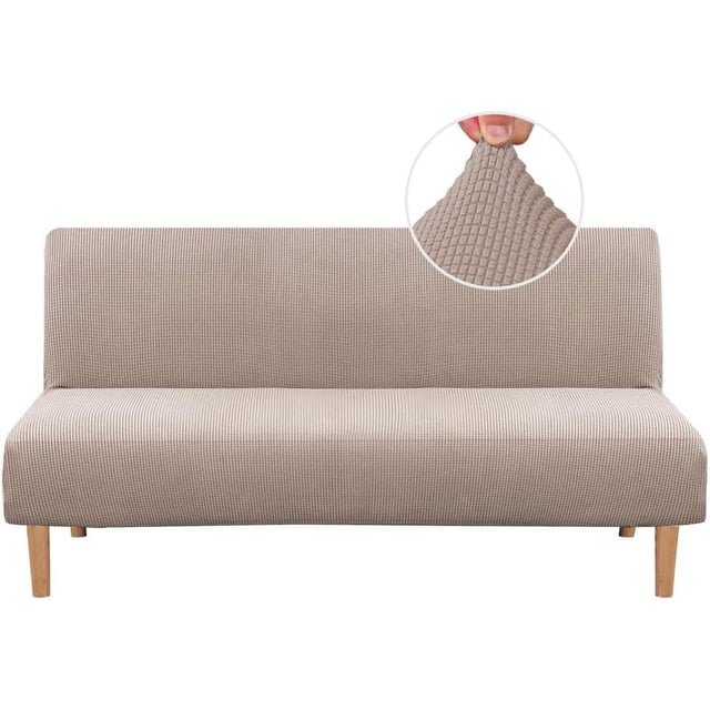 Armless Futon Cover Stretch Sofa Bed Slipcover Protector with elastic, textured high spandex small checks jacquard fabric in a neutral tone. The slipcover is shown fitted on a futon with wooden legs, highlighting its snug fit and stretchable material. A close-up inset displays the textured jacquard pattern. Suitable for futons 68-85 inches wide, it protects against stains and wear, ideal for homes with children and pets. Machine washable for easy maintenance.