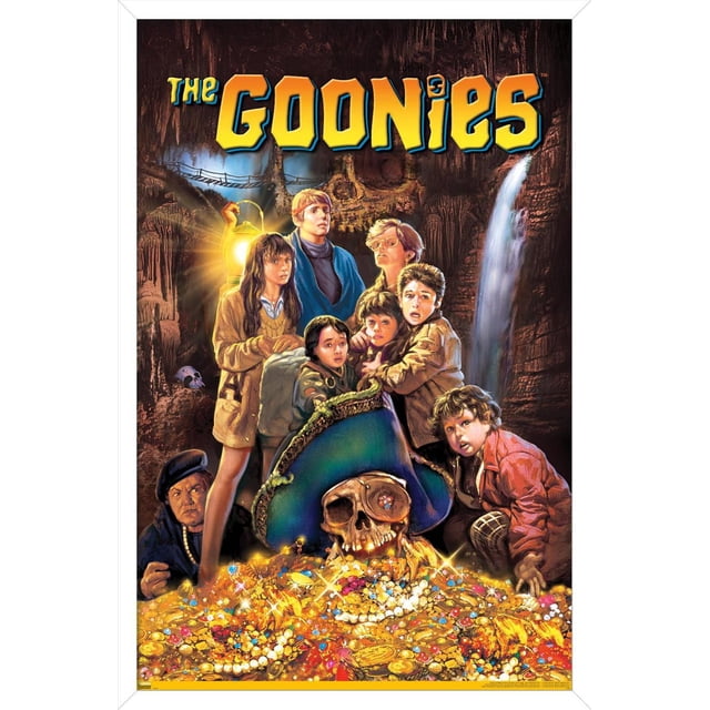 The Goonies - One Sheet Wall Poster, 22.375" x 34" depicting a group of children gathered in a cave lit by a lantern, standing behind a large pirate skull with a blue tricorn hat, surrounded by a treasure hoard of gold coins, pearls, and jewels, with a waterfall and rope bridge in the background, suitable for wall art in bedrooms or offices.