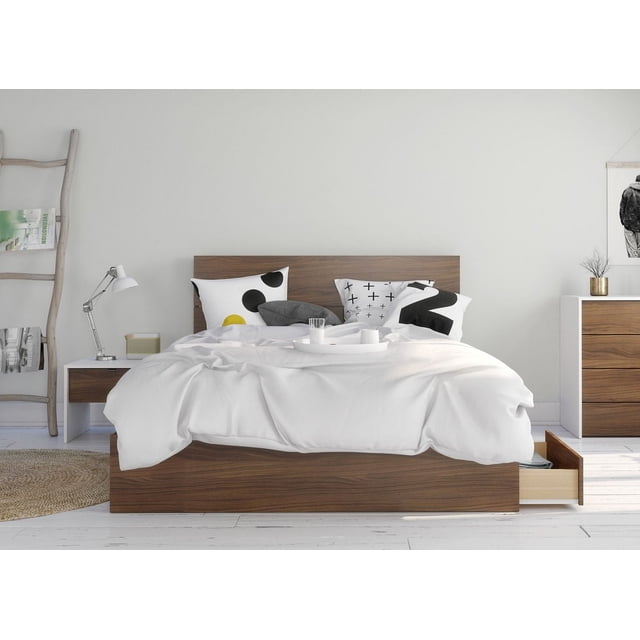 Nexera Foliage 3 Piece Bedroom Set in walnut and white, featuring a 3-drawer storage bed with a walnut finish and horizontal plank headboard, paired with a white and walnut nightstand with a scratch-resistant melamine top and one drawer, shown in a minimalist room with white walls and floor, decorative black and white geometric pillows, and an open storage drawer.