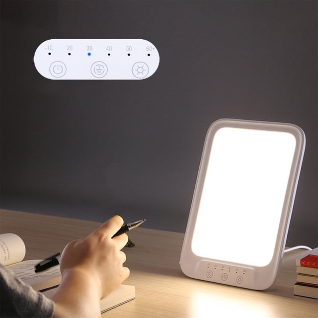 SSZMDLB under $5 Phototherapy Lamp featuring sunlight simulation LED technology, shown on a desk with a user holding a pen. The lamp has a sleek white plastic frame and touch control buttons for adjusting brightness and timer settings, with options for 15, 30, 45, and 60 minutes. Ideal for mood light therapy, office use, or as a reading lamp, it offers up to 10,000 lux of evenly distributed light to improve sleep, mood, and energy levels.