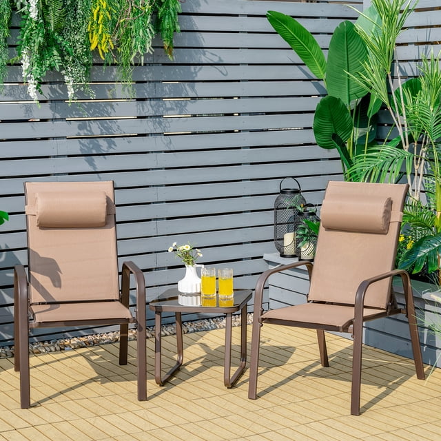 Gymax 3PCS Outdoor Bistro Set Patio Conversation Set in brown, featuring two stackable chairs with adjustable backrests and headrests, and a tempered glass coffee table. The chairs are made with a rustproof steel frame and quick-drying fabric, designed for outdoor use. The compact set is displayed on a patio with greenery and a wooden privacy screen in the background.
