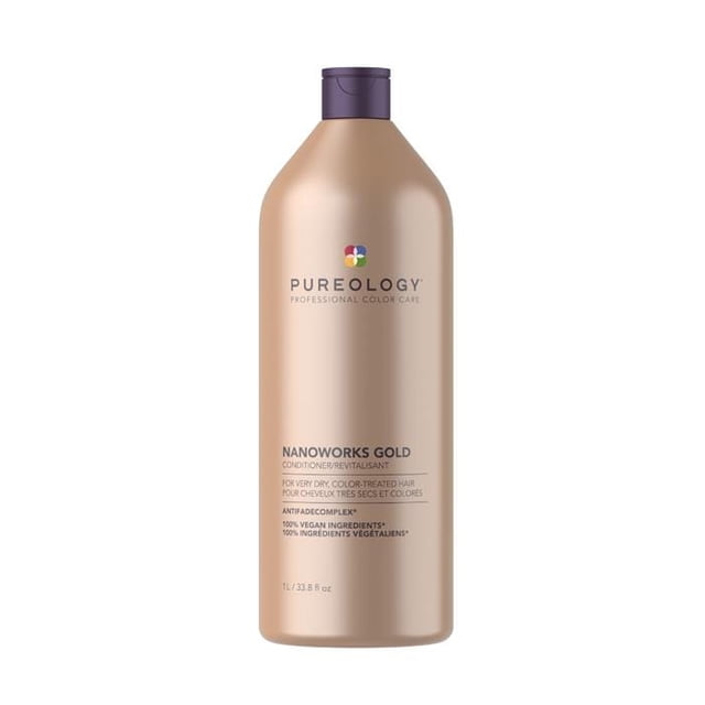Pureology NanoWorks Gold Revitalisant en Bouteille de 1 L avec une Finition Dorée et un Bonnet Violet. Conçu pour les Cheveux Très Secs et Colorés, Il Présente une Formule Riche avec Kéravis et Huile de Marula Dorée pour Restaurer la Douceur, la Gérabilité et la Brillance. l'Après-shampoing Est 100 % Végane, Sans Sulfates, et Comprend un Complexe Anti-Décoloration pour Protéger l'Éclat de la Couleur. des notes d'Aromathérapie de Poire Rosée, d'Ylang-ylang et d'Ambre Doré Améliorent