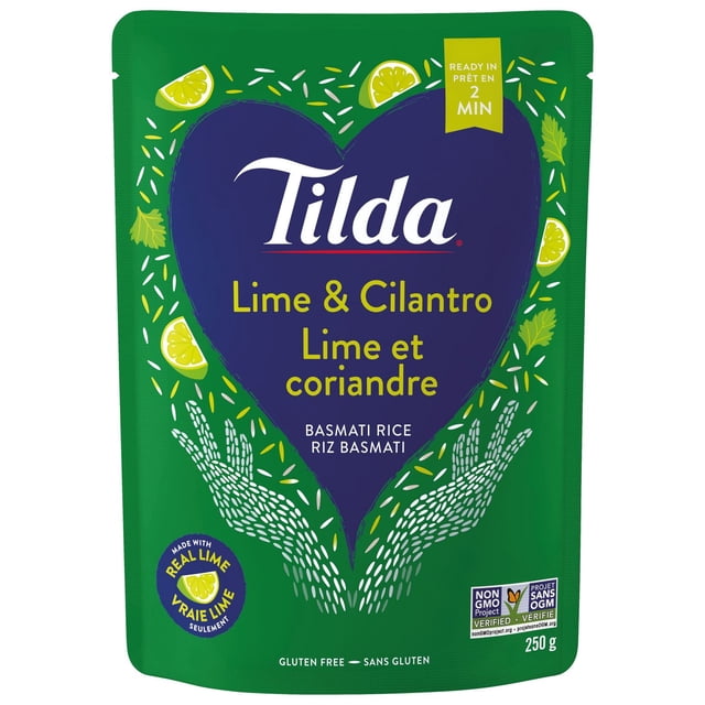 Tilda Lime & Cilantro Steamed Basmati Rice in a green pouch with a large blue heart graphic featuring lime slices and cilantro leaves, labeled gluten free, non-GMO verified, ready in 2 minutes, 250 g package, suitable for quick South Asian dishes.