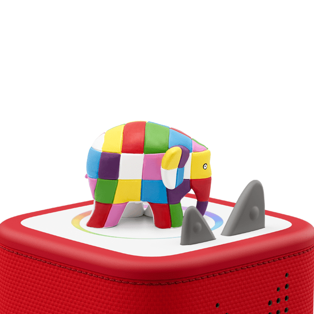 tonies Elmer & Friends Audio Play Figurine featuring a colorful patchwork elephant with red, yellow, green, blue, purple, pink, and white squares on a red fabric-covered audio base with two gray triangular ears, designed for screen-free educational play for kids ages 3 and up.