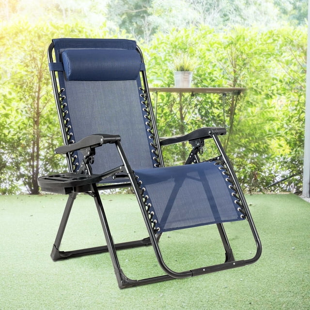 Gymax Folding Zero Weighted Lounge Chair Recliner in navy blue with a steel frame, adjustable backrest, and movable pillow. This zero gravity chair features a cup holder tray for drinks and small items. Lightweight and foldable design suitable for outdoor use, shown on a patio with greenery in the background.