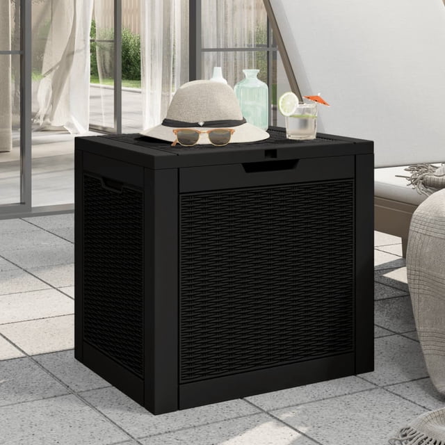 vidaXL Garden Storage Box Black 55.5x43x53 cm Polypropylene placed on a patio. The box features an imitation rattan design, a lockable lid, and ergonomic side handles for easy carrying. It offers a 118 L storage capacity, suitable for garden tools, cushions, or pool toys. The lid doubles as a tabletop, shown here holding a hat, sunglasses, and a drink.