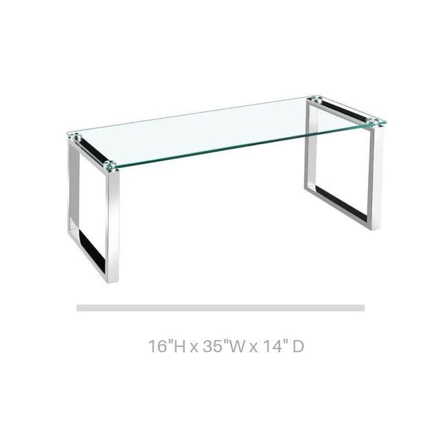 Gyna Large Coffee Table with a solid glass top and shiny chrome legs in a modern rectangular design, measuring 16 inches high, 35 inches wide, and 14 inches deep, ideal for living room use and suitable as a stylish display surface.