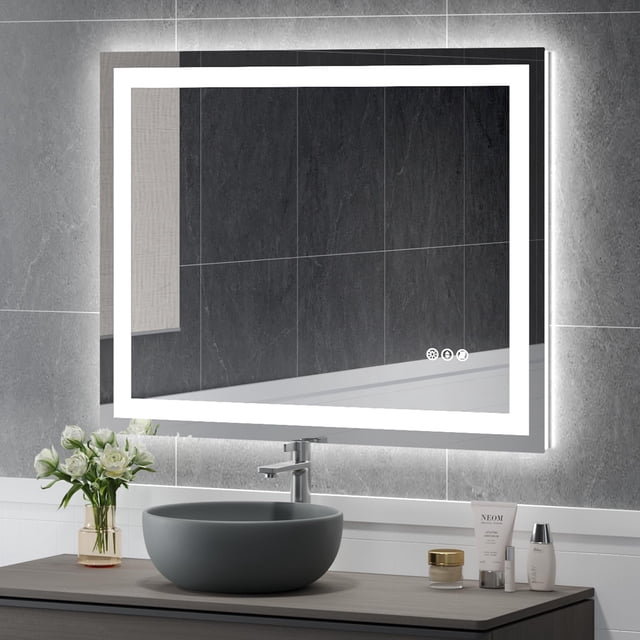 USHOWER Miroir de Salle de Bain Moderne à DEL 40 X 32 Po avec Rétroéclairage Intelligent et Fonction Antibuée, Lumières à Intensité Réglable et installation Murale. Fabriqué en Verre Trempé 1/5 Po, le Miroir s'Affiche dans un Décor de Salle de Bain Contemporain avec un Comptoir Gris, une Bassine Ronde et des Objets Décoratifs.